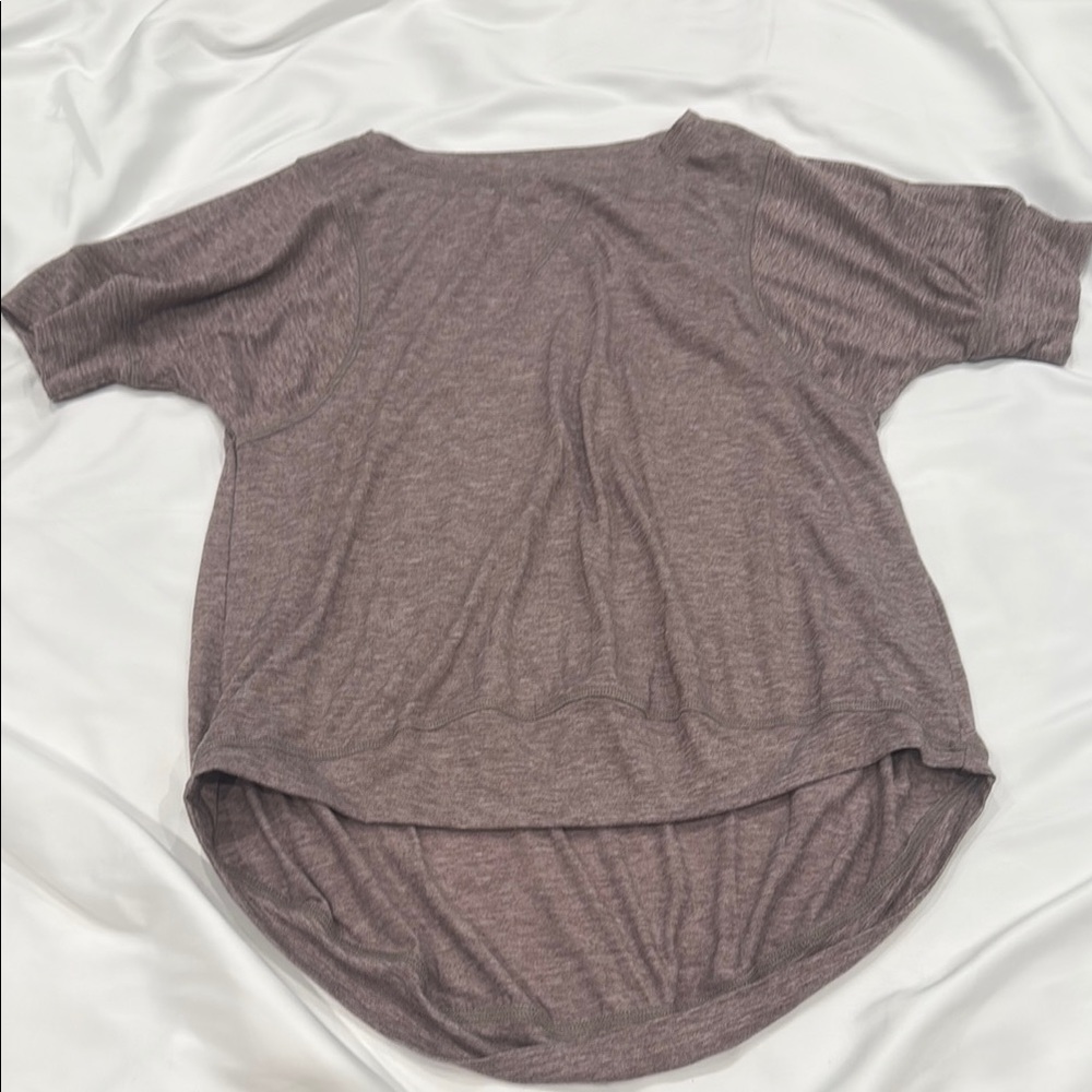 Heathered purple Short Sleeve Top covers bottom